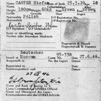 Dark grey form with white text mainly identifying the name, date of birth, nationality, and physical attributes of an individual. The document is signed and stamped with a fingerprint and official stamp.